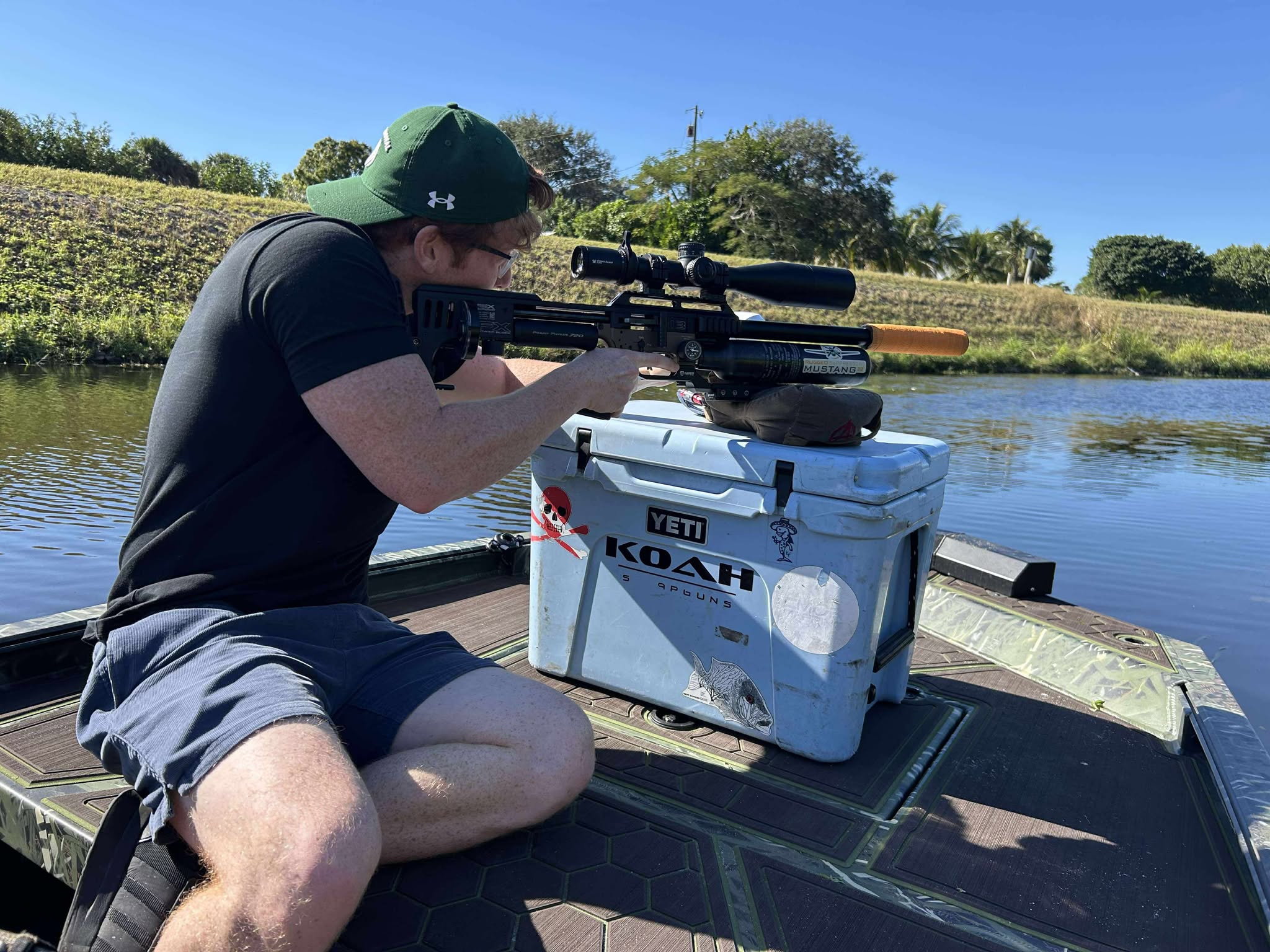 Guest on a boat during a guided South Florida iguana hunting trip