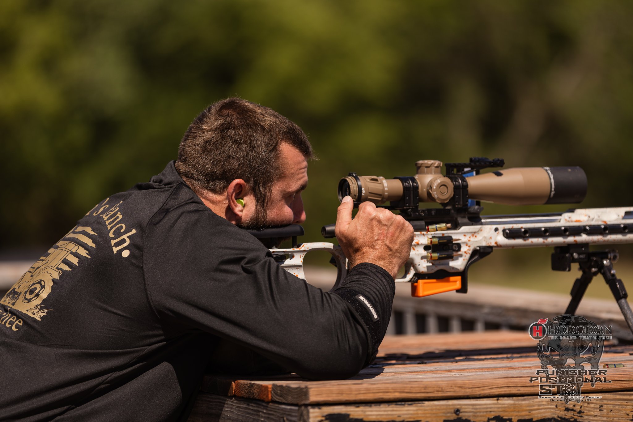 Precision Rifle Series competitor aiming a scoped competition rifle from a supported position